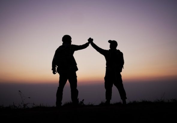 silhouette-teamwork-helping-hand-trust-help-success-mountains-hikers-celebrate-with-hands-up-help-each-other-top-mountain-sunset-landscape_1150-61310
