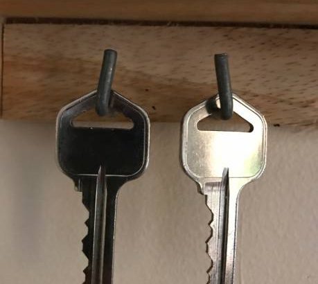 This are 2 sliver keys hanging next to each other